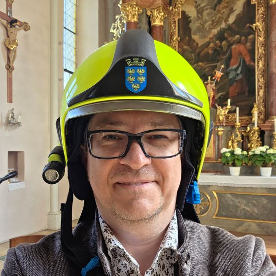 Markus Göstl mit Feuerwehrhelm